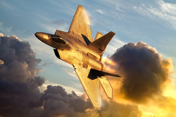 An F-22A Raptor flying above the clouds.