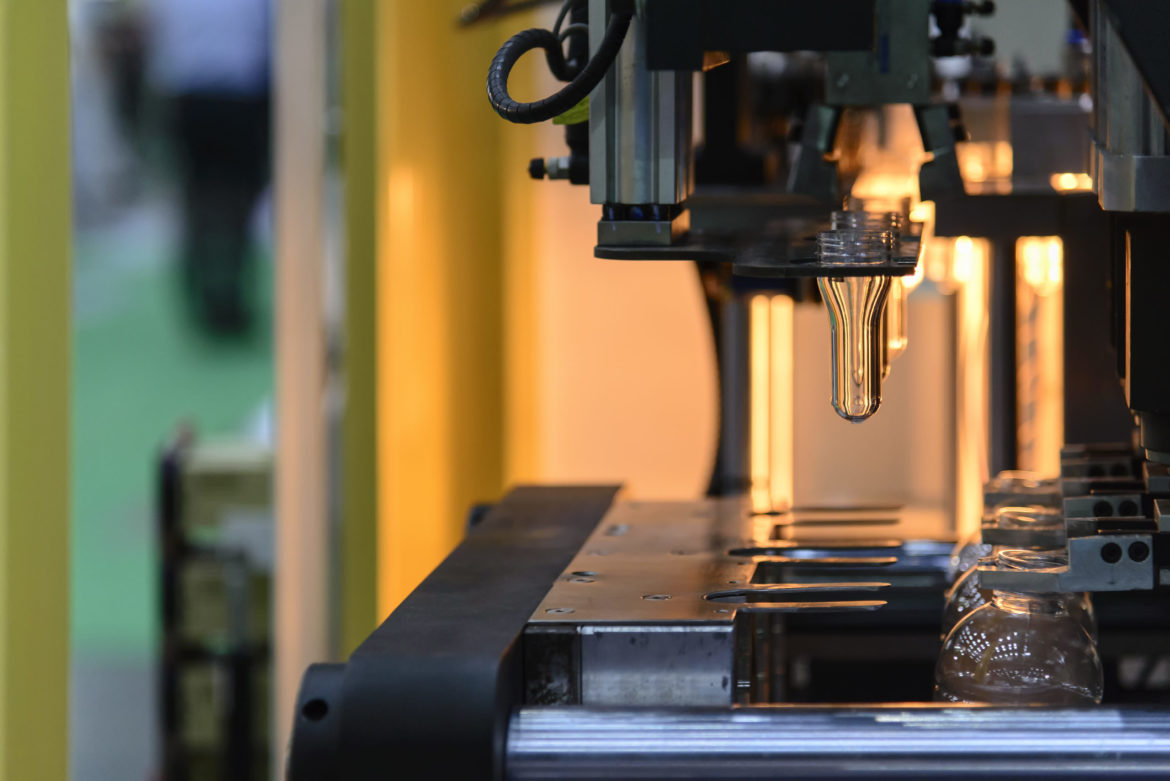 Plastic bottle blow molding machine in a factory