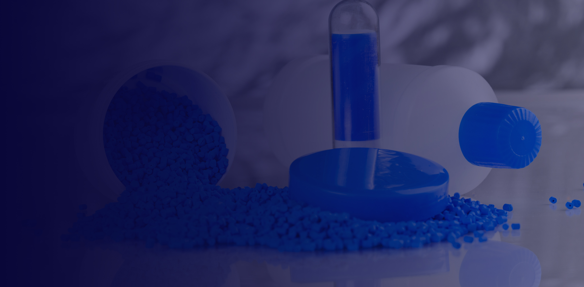 Plastic molding pellets in blue with plastic blow molded bottle