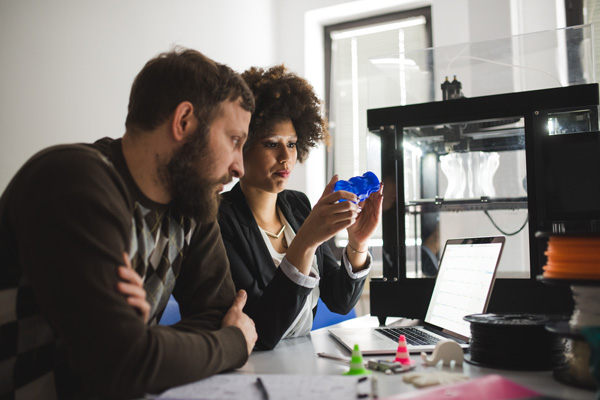 Two people discussing a product prototype