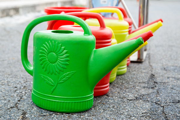 Blow molded watering cans with sunflower design